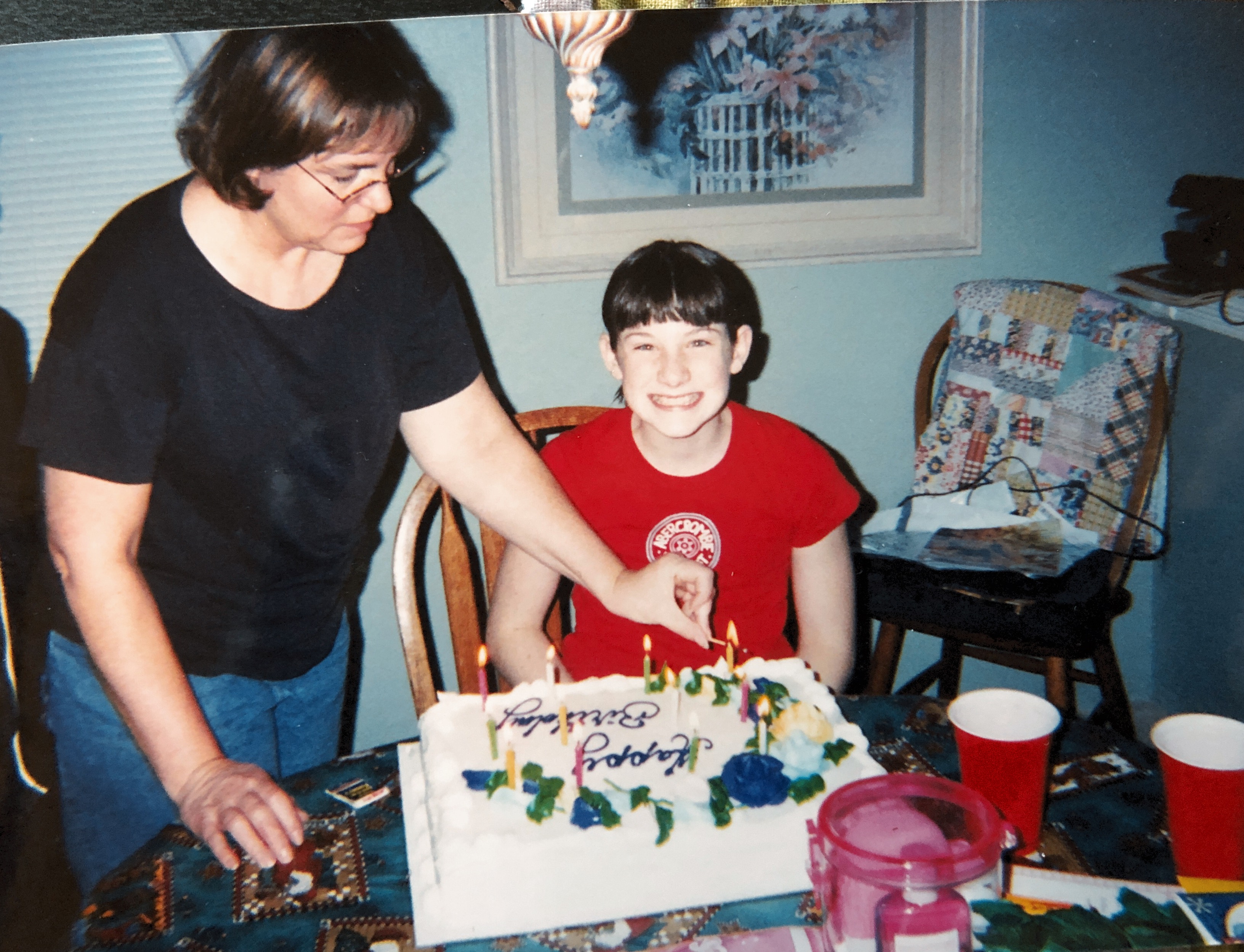 Mom (Rene), birthday girl  Christina with Jimmy looking on.  The Branches!!  Looks like there are 12 candles.  Dec. 16, 2002.  At home in Federal Way.  Great smile!