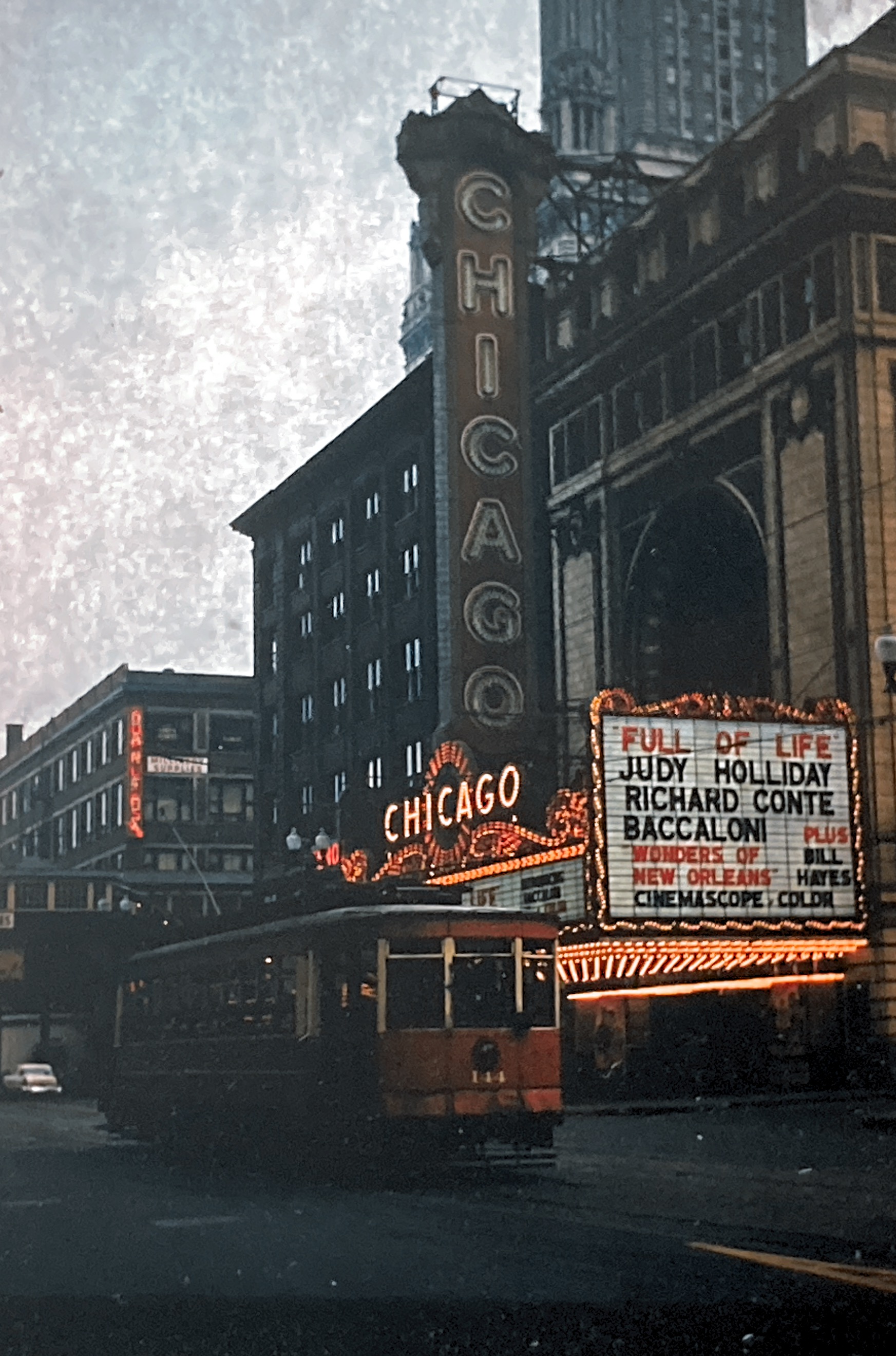 This was taken by my dad n 1958. Iconic Chicago with the Red Streetcar infront of the Chicago Theatet. 