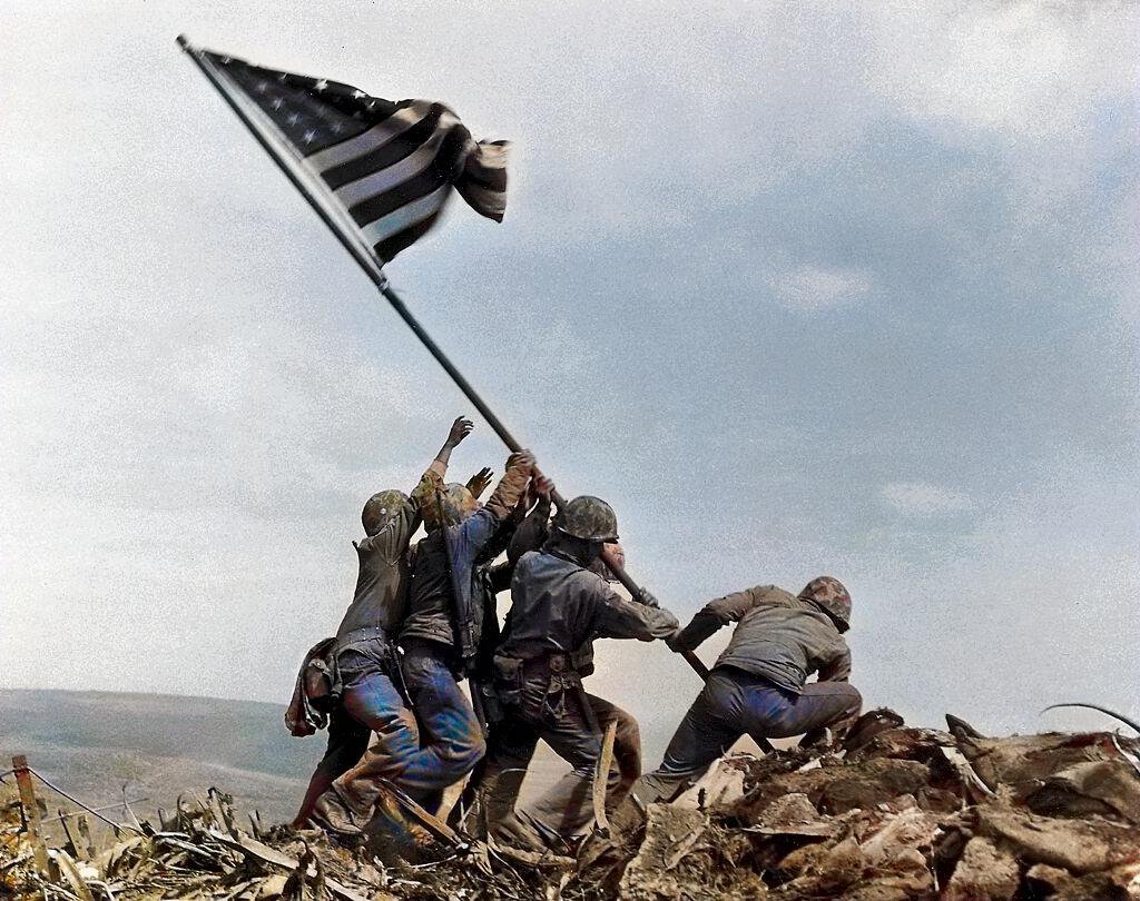 The raising of the American flag on Iwo Jima took place during World War II on February 23, 1945. U.S. Marines captured Mount Suribachi on the island of Iwo Jima, which was a crucial strategic location. The iconic photograph capturing the moment was taken by Joe Rosenthal and depicts six Marines raising the flag atop Mount Suribachi. The image became a symbol of American victory and determination in the war. The battle for Iwo Jima lasted until March 26, 1945, and the capture of the island was a pivotal moment in the Pacific campaign.