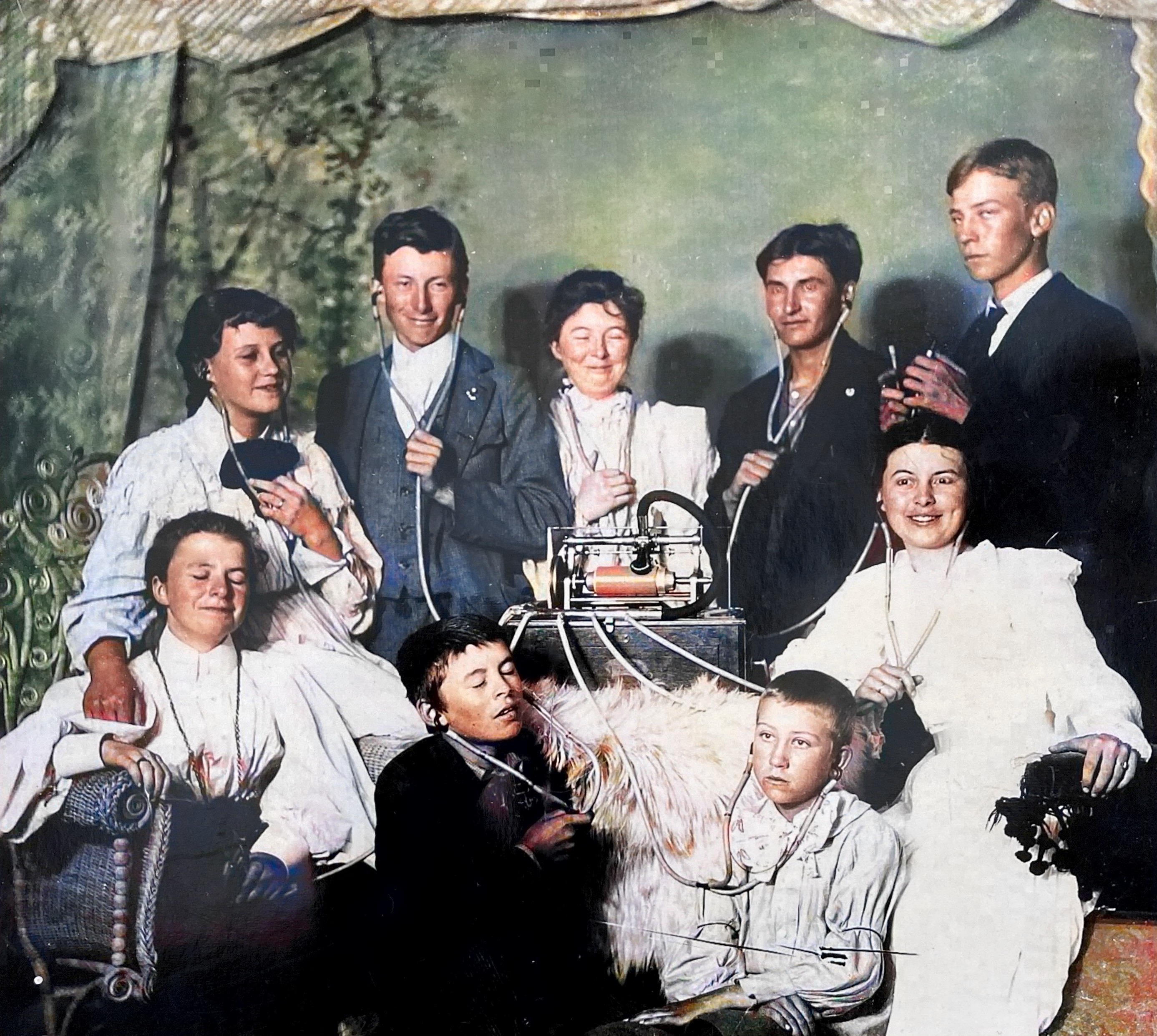 Alice McFadden (far left, back row) listen to Wax Cylinder, which was invented and commercially sold in late 1880s. Picture date estimate 1900 (Alice born 1881).