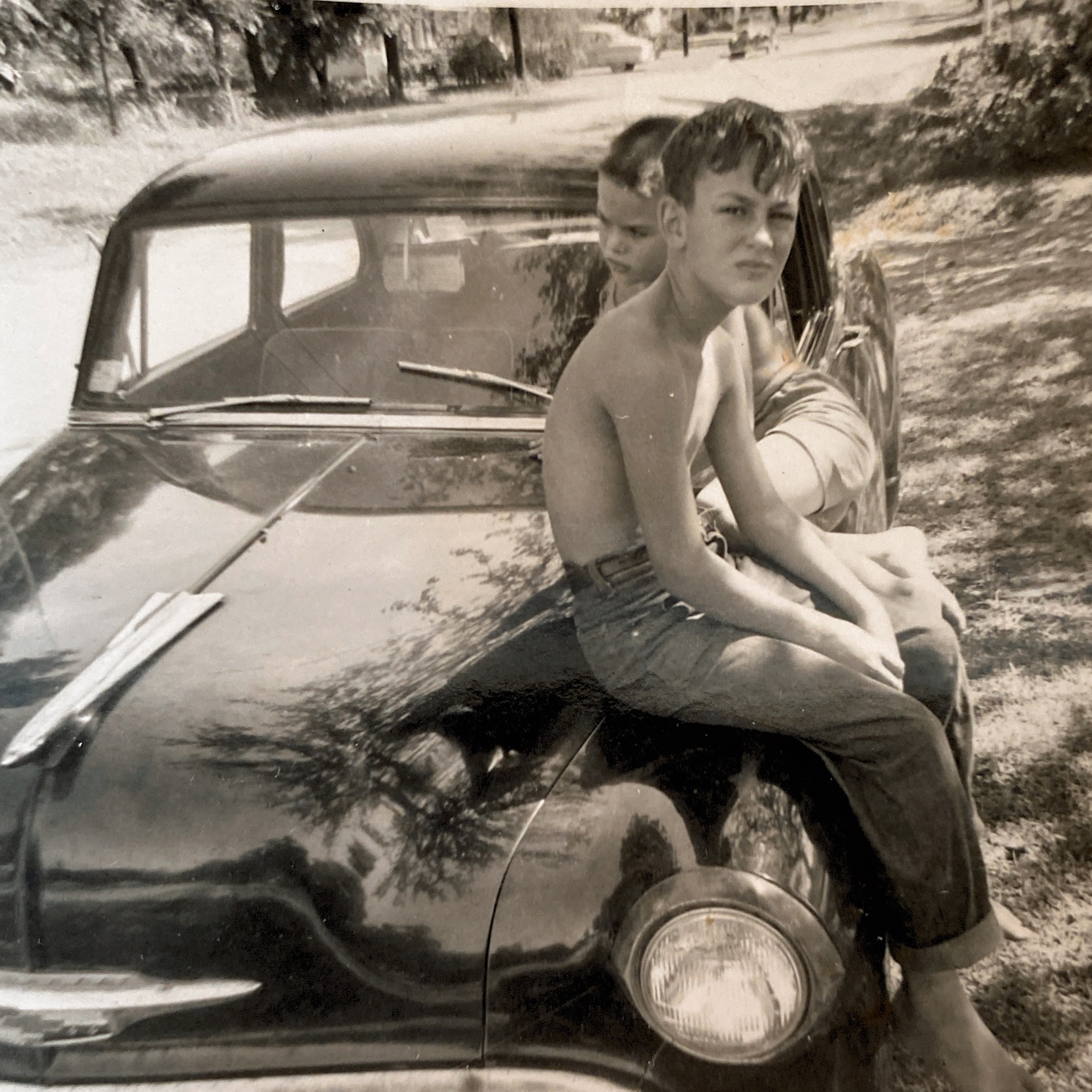 Jerry & Bill Spencer sitting on unknown car; Sept. 1959.  Jerry is 11; Bill is 8.