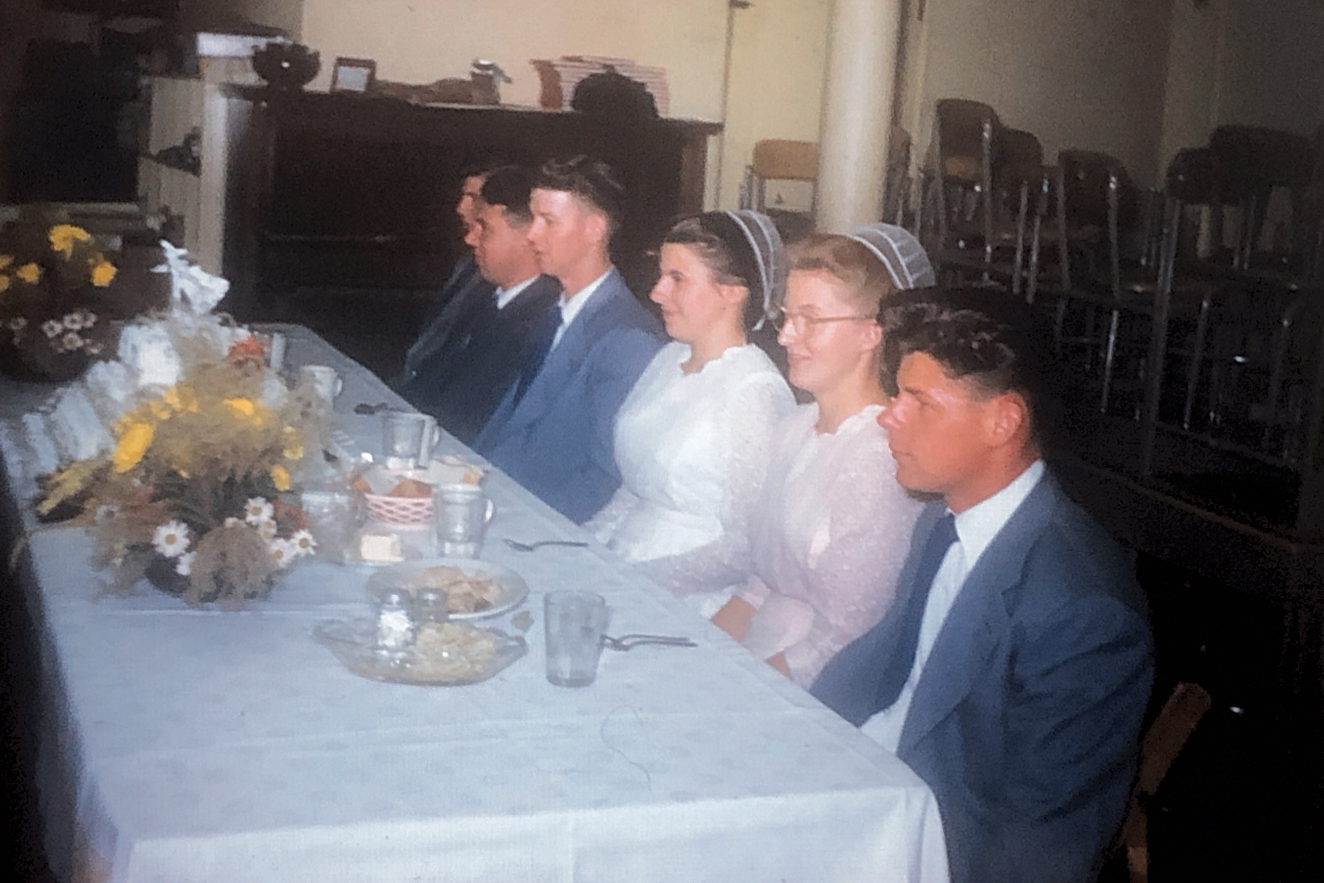 Mennonite wedding party circa 1950. My mother Thelma second from the right an my father John 5th from the right. Note the white “coverings” on the women. 