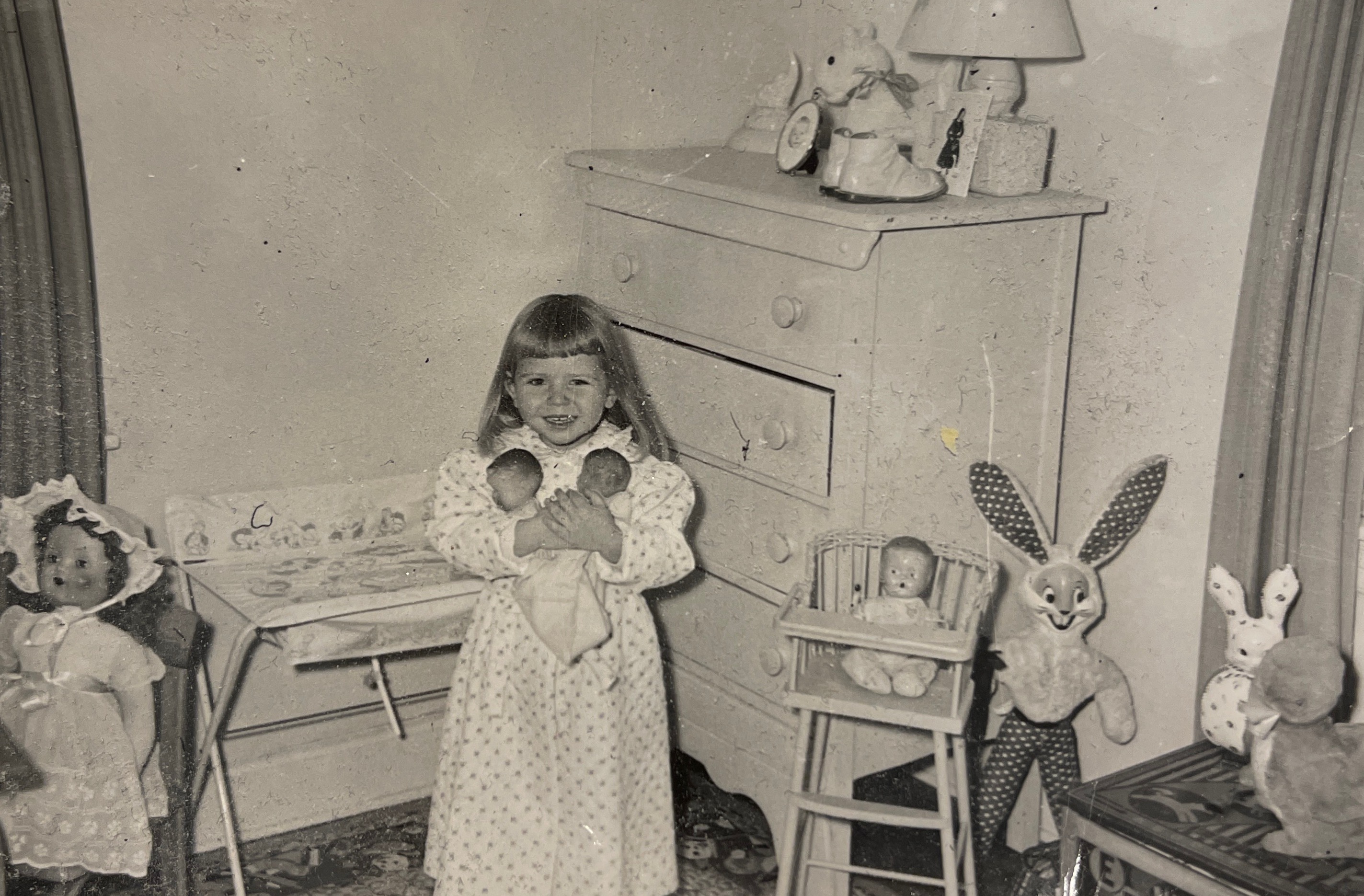 Claudia Dumas with twin dolls, December 1955. 26 years later, she would give birth to twin daughters.
