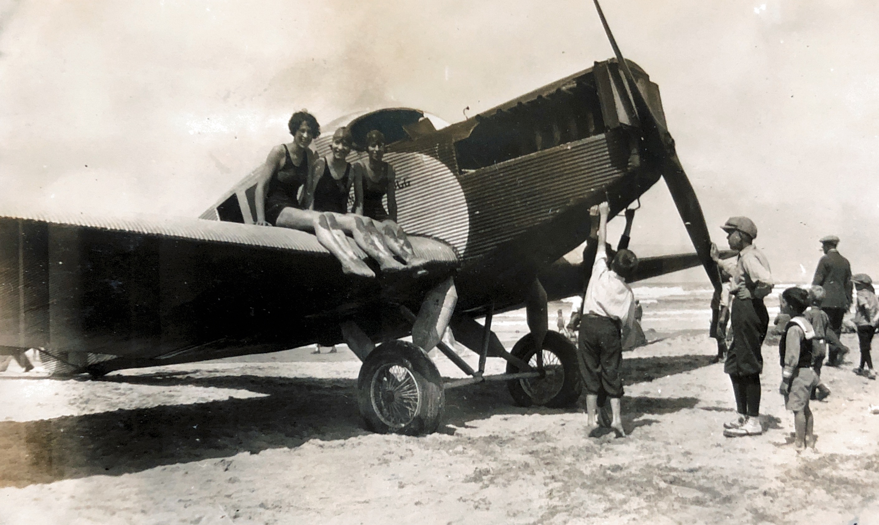 Southern Oregon coast, Marjorie and Friends, checking out the airplane. Abt. 1919