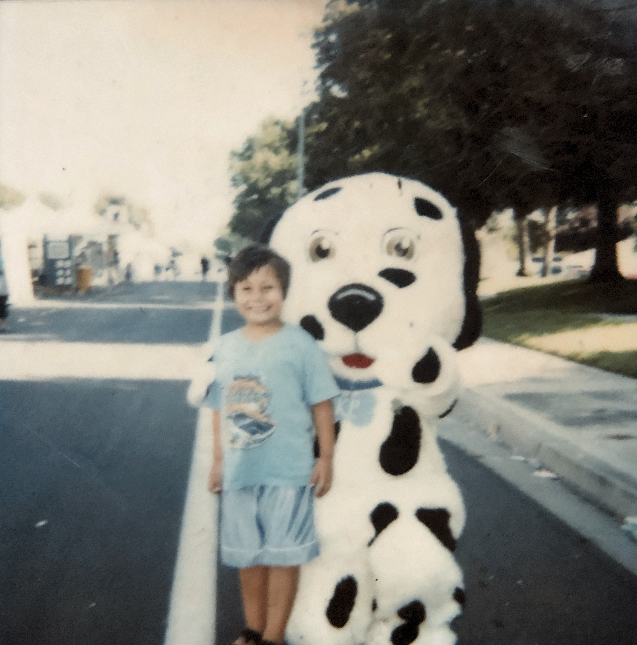 This is a very old photo of my grandpa from 1948 he was taking a picture with some type of mascot but I’m not quite sure who it is.