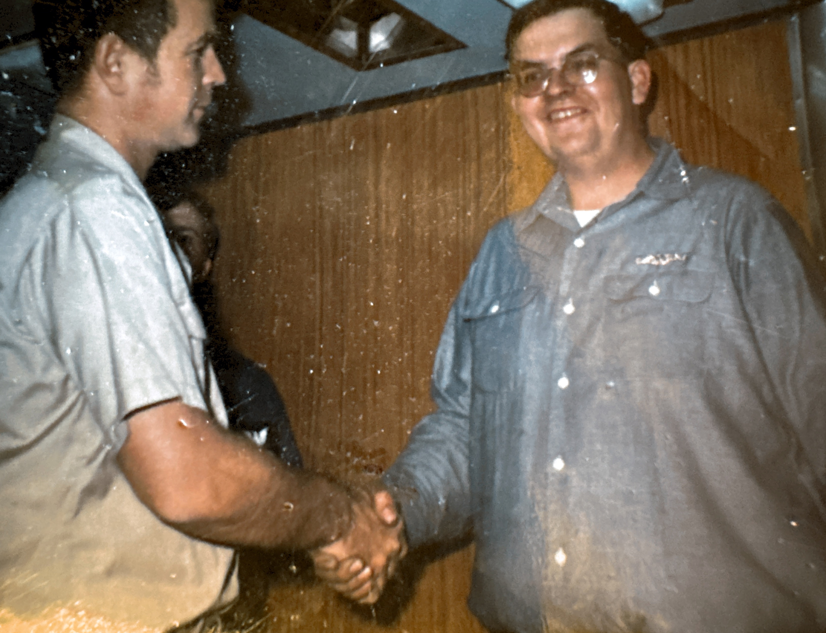 Cmdr. George Dewhirst congratulates Bill Thomas for passing the board and being “Qualified in Submarines.” In the Wardroom of USS Permit (SSN594) June 20 1976.