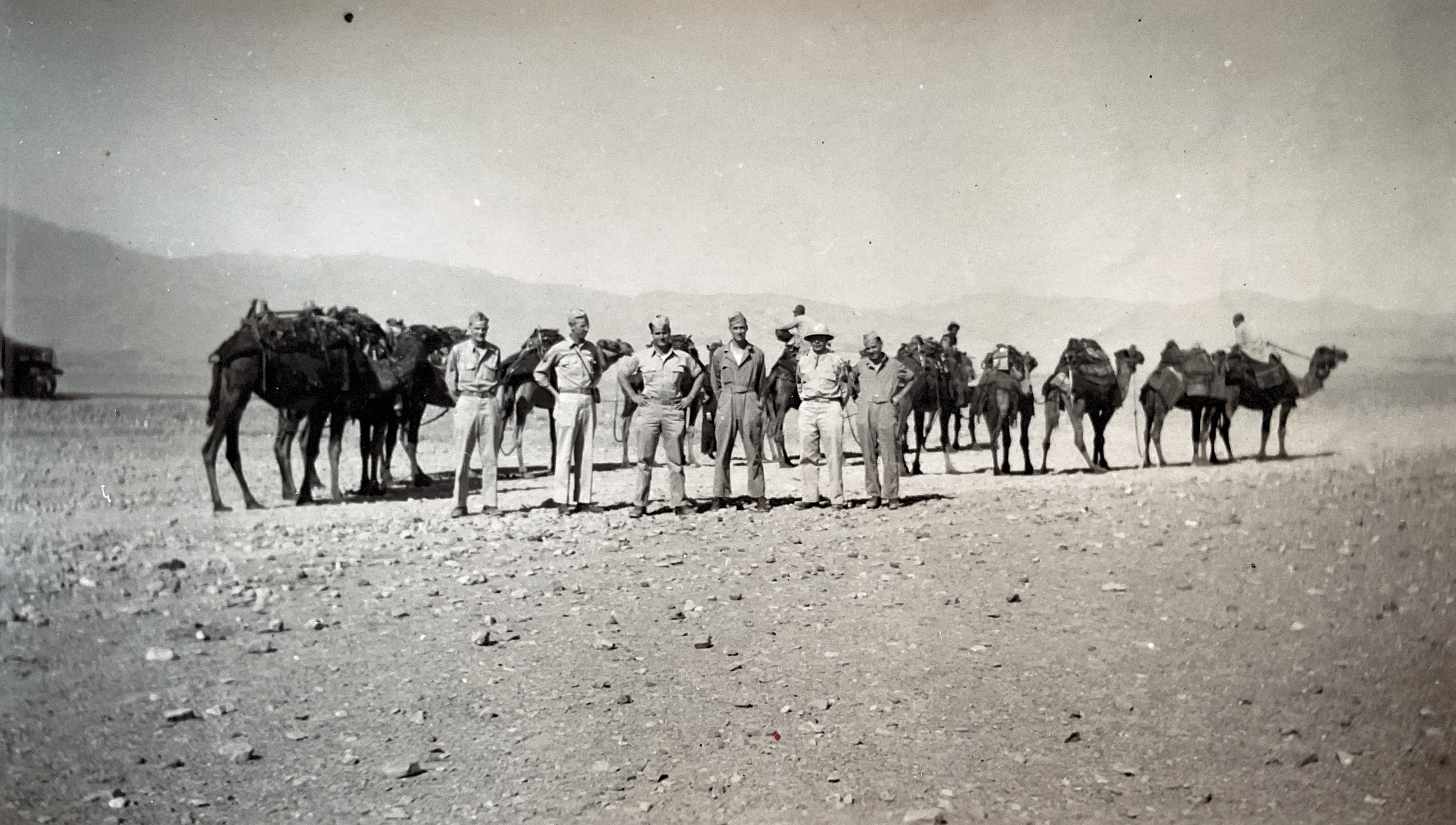 “I am on the extreme right. Taken on a mountain trip one Sunday P.M.” Persia 1943. Camel Caravan.