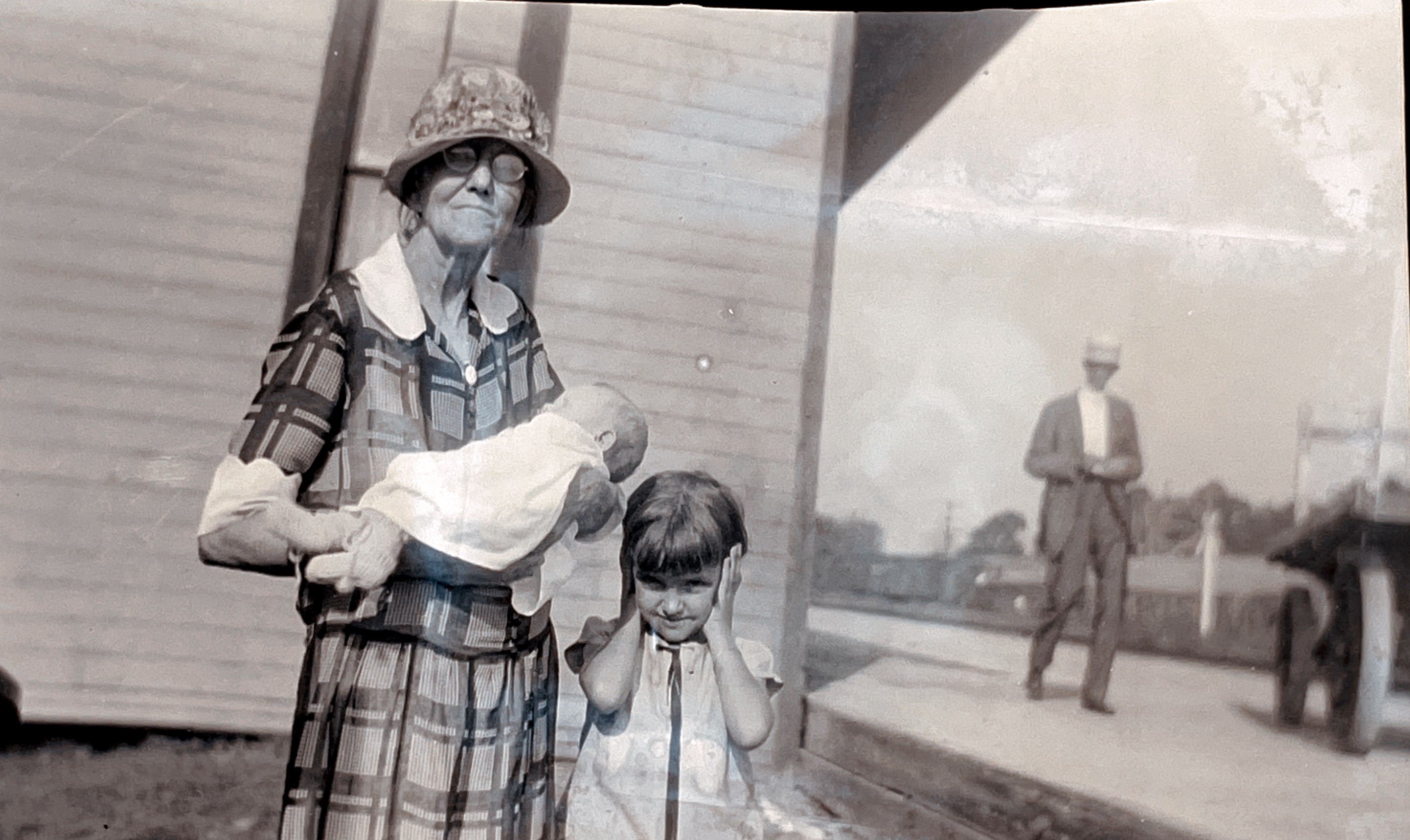 Mayor of Jefferson, Texas R. B. Walker in the background, his wife holding their new grandson Bobby while  sister Betty Jane isnt so sure about the new baby! Betty Jane was my husband’s mom. 1933. 