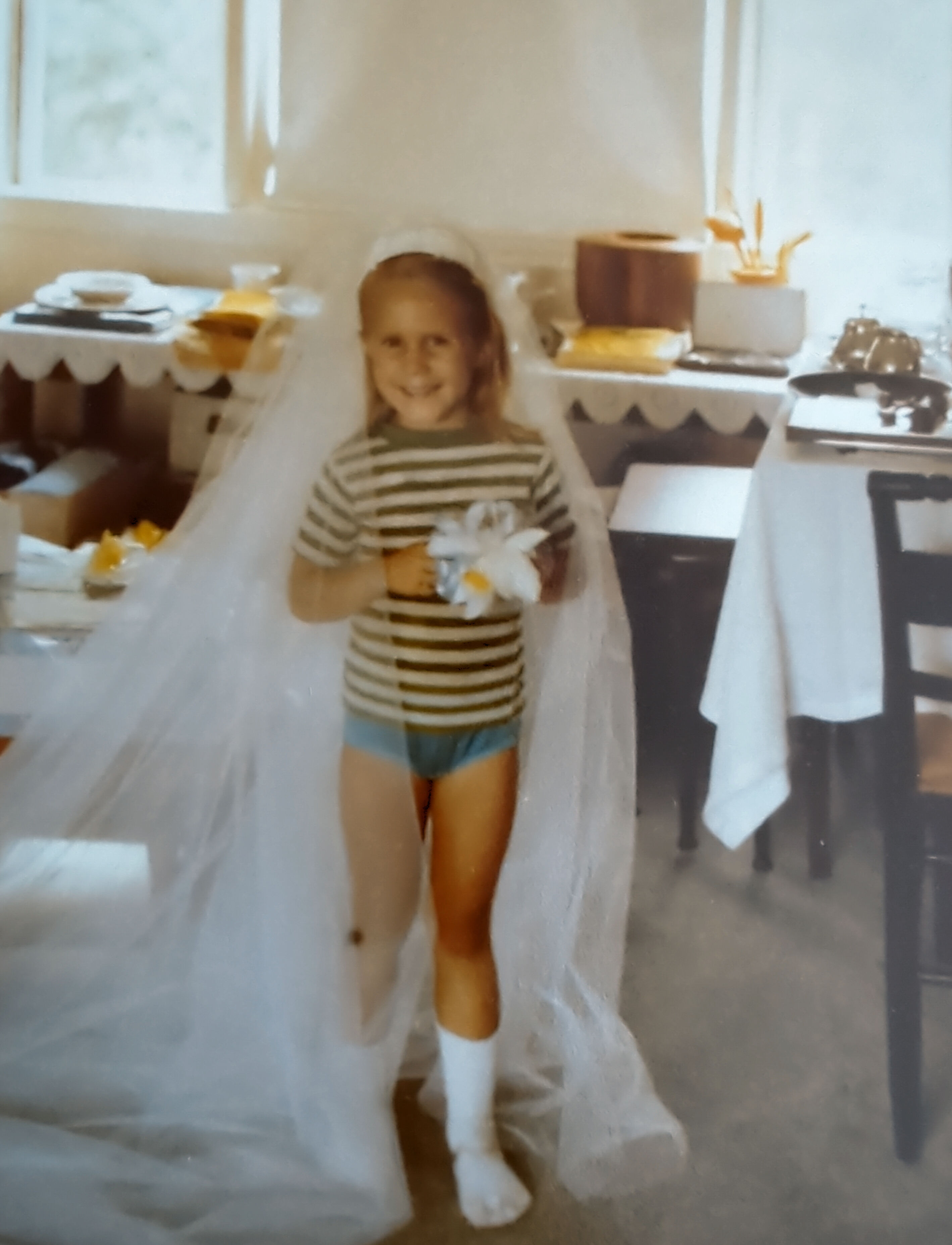 Adrianne trying on lizbes' wedding veil august 1978
