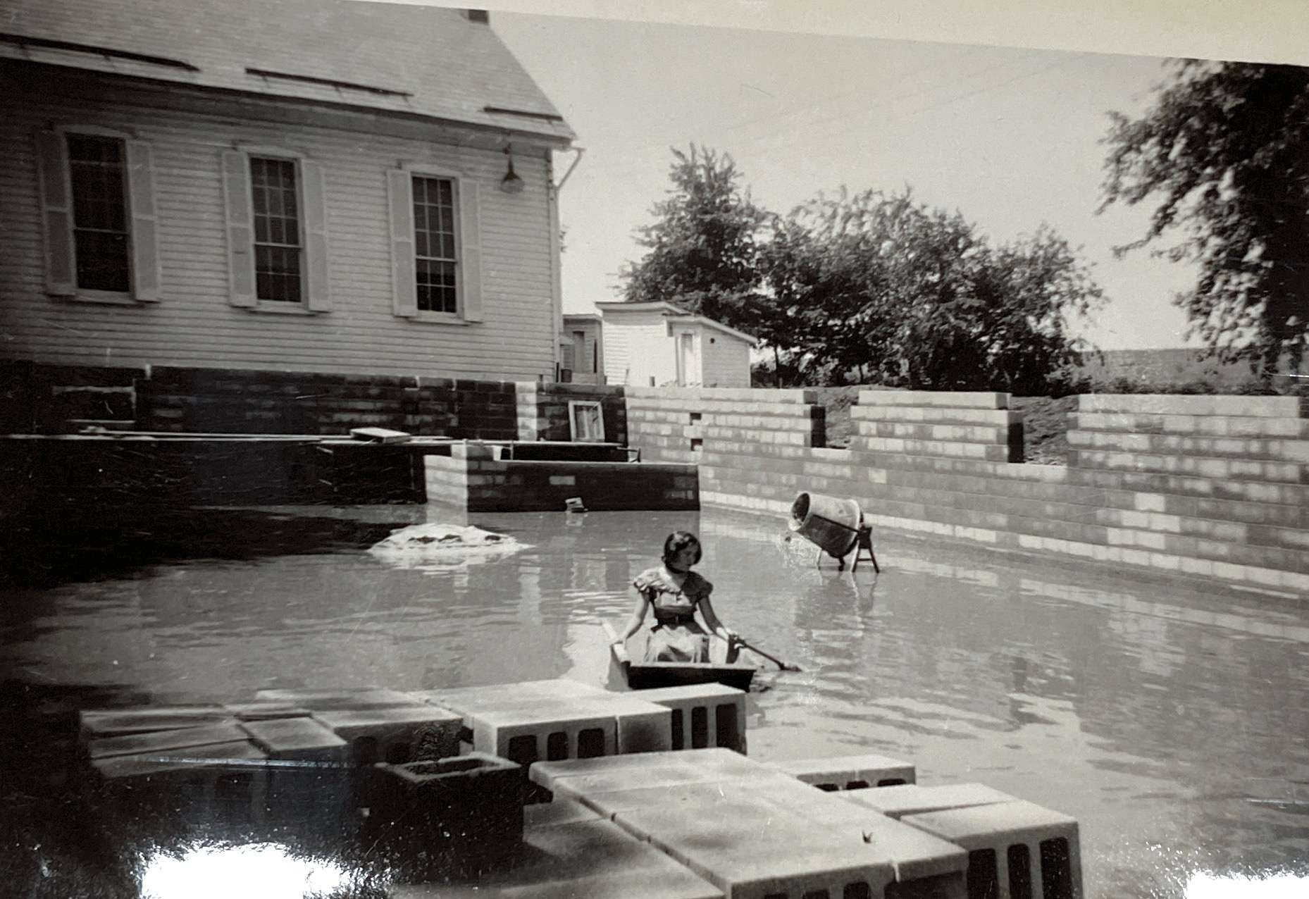 Pat Berger floating in a mortar box. This in inside the excavated area that would become the basement in the Hollowell Church addition in 1954 (photo provided by Howard Bingaman)
