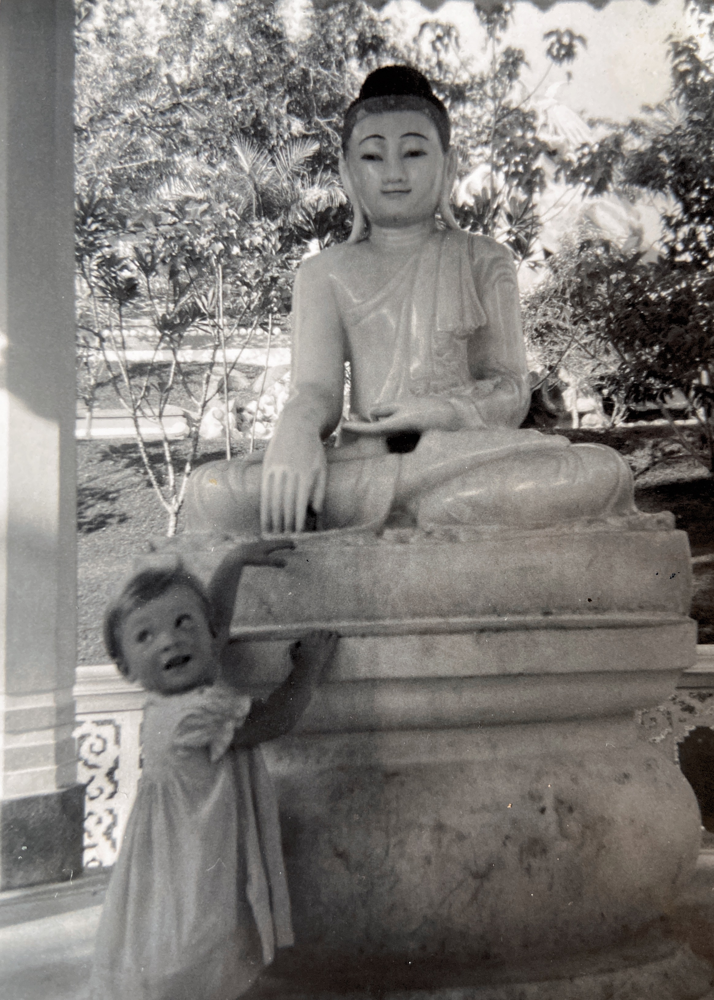 April 1956 At Haw Par Villa. This was made by creators of Tiger Balm. There is also a photo of Christine who went back there in 2022 to see the same place.